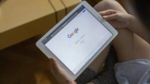 Close-up of hands holding a tablet showing the Google search page. - Close-up of hands holding a tablet showing the Google search page., tags: apple facilitating illegal - pexel