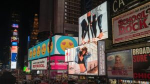 Colorful billboards light up New York City's iconic Times Square at night, with vibrant ads and bustling crowds., tags: campaigns - pexel