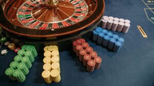 Vibrant poker chips stacked beside a roulette wheel in a casino setting., tags: google gambling starting august - pexel