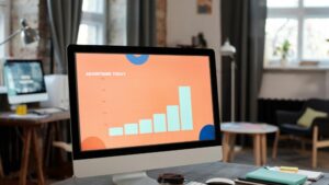 Contemporary office desk setup with computer displaying a business chart., tags: paid ads agency - pexel