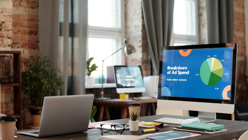 A modern office workspace featuring computers, charts, and office supplies for a productive environment., tags: paid - pexel