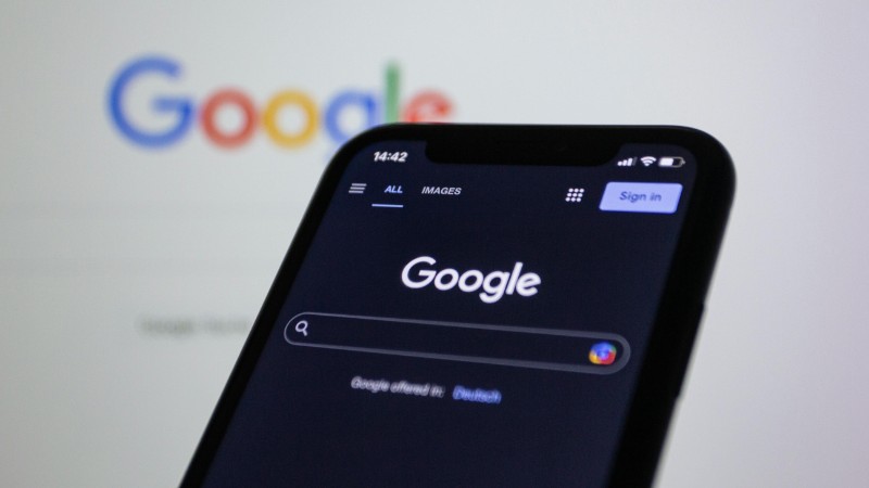 Smartphone screen showing Google search in dark mode with the Google logo in the background., tags: gambling - pexel